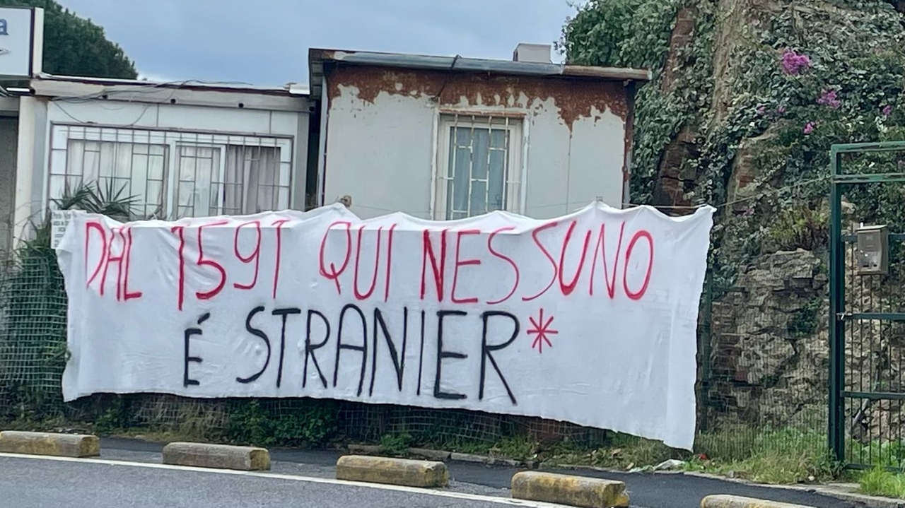 Uno degli striscioni di benvenuto per i migranti (Foto Novi)